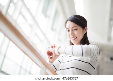 Beauty Woman Looks Watch With White Corridor, Asian