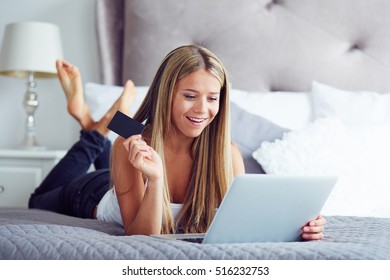 Beauty Woman Lying On The Bed And Shopping Online With Notebook