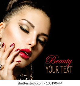Beauty Woman with Perfect Makeup. Beautiful Professional Holiday Make-up. Red Lips and Nails. Beauty Girl's Face isolated on Black background