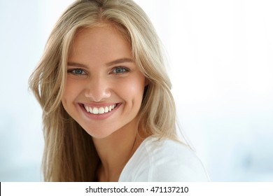Beauty Woman Portrait. Closeup Of Beautiful Happy Girl With Perfect Smile, White Teeth Smiling At Camera. Attractive Healthy Young Female With Fresh Natural Face Makeup Indoors. High Resolution Image