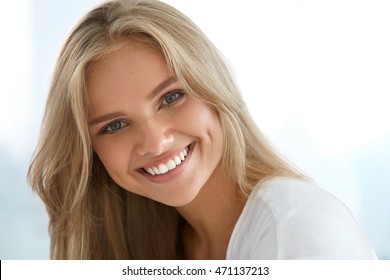 Beauty Woman Portrait. Closeup Of Beautiful Happy Girl With Perfect Smile, White Teeth Smiling At Camera. Attractive Healthy Young Female With Fresh Natural Face Makeup Indoors. High Resolution Image