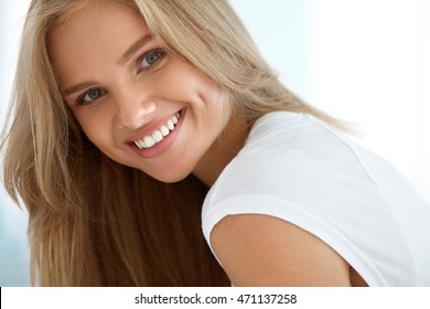 Beauty Woman Portrait. Closeup Of Beautiful Happy Girl With Perfect Smile, White Teeth Smiling At Camera. Attractive Healthy Young Female With Fresh Natural Face Makeup Indoors. High Resolution Image