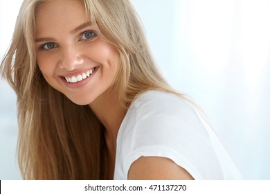 Beauty Woman Portrait. Closeup Of Beautiful Happy Girl With Perfect Smile, White Teeth Smiling At Camera. Attractive Healthy Young Female With Fresh Natural Face Makeup Indoors. High Resolution Image