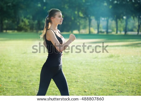 Beauty woman running in the morning park