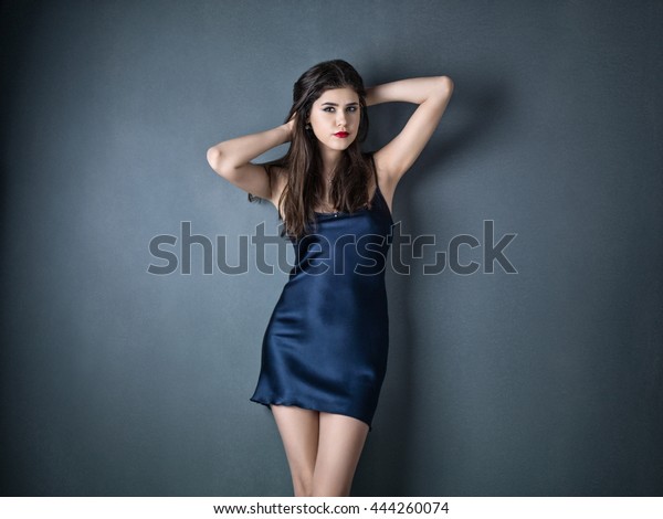 Beauty woman in a
silk slip on gray
background