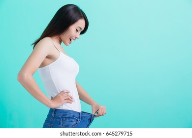 Beauty Woman With Slim Waist On The Green Background