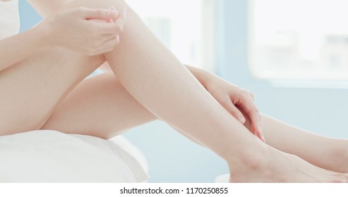beauty woman use cream with her leg at home
