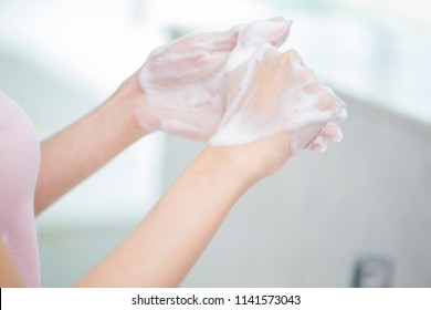 beauty woman wash her hand in the bathroom - Shutterstock ID 1141573043