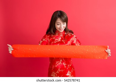 beauty woman wear cheongsam and show couplets with chinese new year