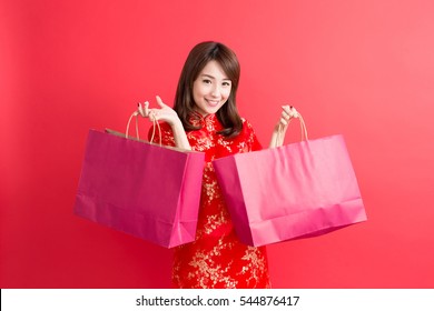 Beauty Woman Wear Cheongsam And Take Shopping Bag In Chinese New Year