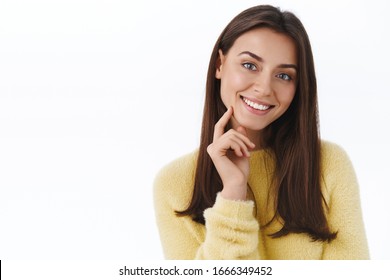 Beauty, Women Face Concept. Close-up Portrait Of Beautiful Young Modern Brunette Woman With No Blemishes And Makeup, Looking Cute, Touching Jawline Gently Smiling Camera, White Background