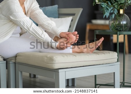 Beauty women's feet with smooth skin in the home interior, foot care and self-massage, BeH3althy concept photo