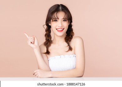 Beauty young asian woman has two pigtails and smiles clean fresh bare skin concept. Asian girl beauty face skincare and health wellness, Facial treatment, Perfect skin, Isolated on beige background.