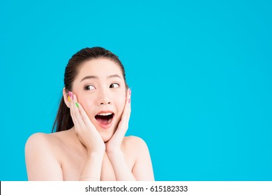 Beauty Young Asian Woman Portrait Isolated On Blue Background With Surprise Action With V Shape Hand On Face. Half Naked Attractive Asian Woman, Long Brown Hair, Black Eyes, Posing Shocking Face.