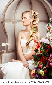 Beauty Young Bride Alone In Luxury Vintage Interior With A Lot Of Flowers, Makeup And Creative Hairstyle