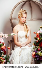 Beauty Young Bride Alone In Luxury Vintage Interior With A Lot Of Flowers, Makeup And Creative Hairstyle