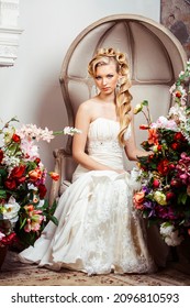 Beauty Young Bride Alone In Luxury Vintage Interior With A Lot Of Flowers, Makeup And Creative Hairstyle