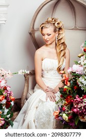 Beauty Young Bride Alone In Luxury Vintage Interior With A Lot Of Flowers, Makeup And Creative Hairstyle