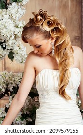 Beauty Young Bride Alone In Luxury Vintage Interior With A Lot Of Flowers, Makeup And Creative Hairstyle