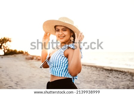 beauty young woman with brackets wearing a hat on the beach.