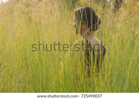 Beauty young woman outdoors  green grass enjoying nature at sunset. blurred nature background, Blurred photo.