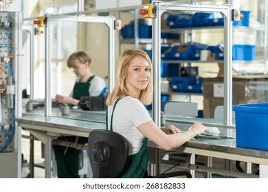 Beauty young woman working on production line