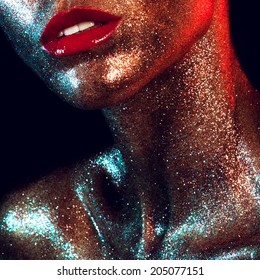 Beautyful girl with gold glitter on her face