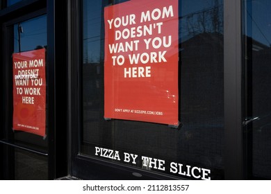 Beaverton, OR, USA - Jan 25, 2022: Creative hiring ads are seen at the Sizzle Pie restaurant in Beaverton, Oregon, amid a nationwide labor shortage. Sizzle Pie is an American regional pizza chain.