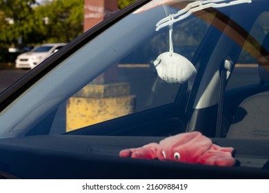 Beaverton, OR, USA - May 19, 2022: A used mask is seen hanging inside a car in a parking lot in Beaverton, Oregon.