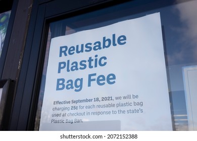 Beaverton, OR, USA - Nov 5, 2021: A notice about the newly-effective Reusable Plastic Bag Fee is seen at the entrance to the Uwajimaya grocery store in Beaverton, Oregon.