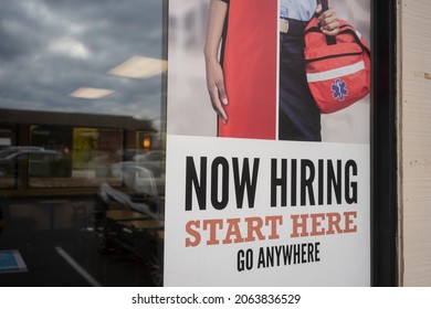 Beaverton, OR, USA - Oct 21, 2021: Now Hiring poster is seen at an Arby's restaurant in Beaverton, Oregon. Workers left their jobs at a record pace in August, led by food and retail industries.