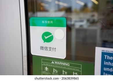 Beaverton, OR, USA - Oct 21, 2021: Closeup of the door sticker advertising WeChat Pay as a payment option seen at the entrance to the 99 Ranch Market in Beaverton, Oregon.