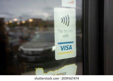 Beaverton, OR, USA - Sep 10, 2021: Tap To Pay With VISA Sticker Is Seen On A Restaurant Door In Beaverton, Oregon. Tap To Pay Is A Contactless Technology Enabling Merchants To Accept Payment Securely.