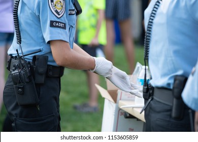 Beaverton, OR / USA - August 7 2018: Police Cadet Putting White Gloves On At The Park Event.