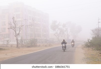 Beawar, Rajasthan, India, Jan. 3, 2021: Commuters travel for work amid dense fog during a cold winter morning in Beawar. Photo: Sumit Saraswat - Powered by Shutterstock