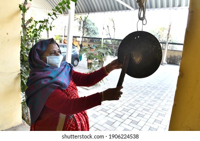 Beawar, Rajasthan, India, January 18, 2021: A Worker Rings Bell At A Government School That Was Reopened After Remaining Closed For 309 Days Due To COVID-19 Pandemic In Beawar. Photo: Sumit Saraswat