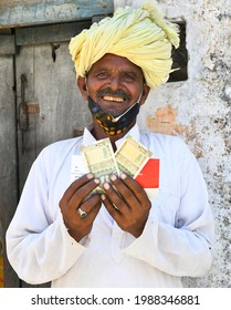 Beawar, Rajasthan, India, June 9, 2021: A Beneficiary Shows Money That He Received As COVID Relief From Rajasthan Government, Outside A Bank At Liri Village Near Beawar. Photo: Sumit Saraswat