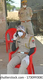 Beawar, Rajasthan, India - May 1, 2020: An Indian Police Officer Wears An N95 Mask And Gloves During Government Imposed Nationwide Lockdown In Wake Of The Coronavirus Pandemic.