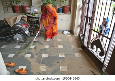 Beawar, Rajasthan, India, May 26, 2021: A Woman Cleans Her House With Broom After Dust Storm Due To Cyclone Yaas In Beawar. Photo: Sumit Saraswat