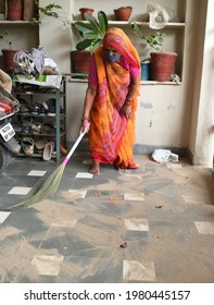 Beawar, Rajasthan, India, May 26, 2021: A Woman Cleans Floor With Broom At Her House After Dust Storm Due To Cyclone Yaas In Beawar. Photo: Sumit Saraswat