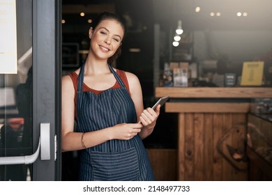 Because You Need A Break From Your Daily Routine. Portrait Of A Confident Young Woman Standing In The Doorway Of A Coffee Shop.