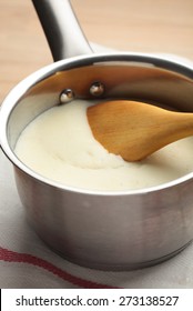 Bechamel In A Sauce Pan With Wooden Spoon