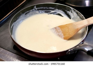 Bechamel. Stir The Creamy Sauce In A Pan With A Wooden Spatula