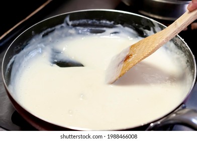 Bechamel. Stir The Creamy Sauce In A Pan With A Wooden Spatula