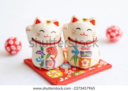 
A beckoning cat. Lucky cat. It is written as ``Shōfuku'' in Japanese.