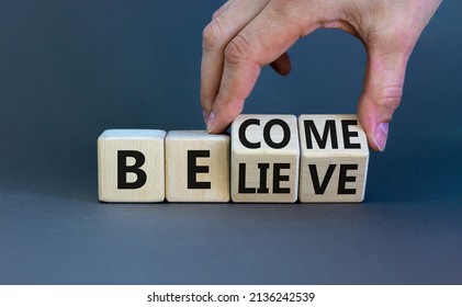 Become or believe symbol. Businessman turns wooden cubes and changes the concept word Believe to Become. Beautiful grey table grey background. Business become or believe concept. Copy space.