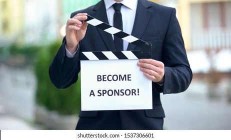 Become A Sponsor Phrase On Clapperboard In Hands Of Producer, Independent Movie