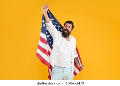 Becoming American Citizen. Happy Hipster Celebrate Independence Day. Bearded Man Hold American Flag Yellow Background. July 4th Celebration. American Traditions. Democracy And Rights. American Dream.