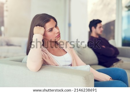Becoming disconnected. Portrait of a young woman giving her husband the silent treatment after a fight.