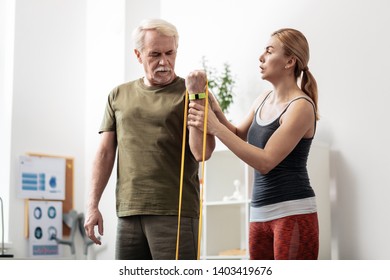 Becoming Stronger. Serious Aged Man Training His Hand Muscles While Wanting To Become Stronger